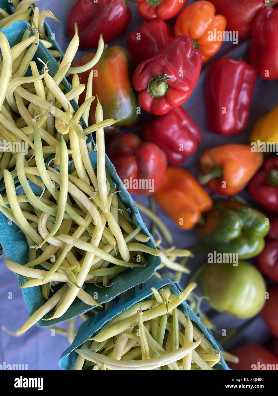 Overhead-Ansicht von Stringbohnen und Paprika auf dem Bauernmarkt. Stockfoto