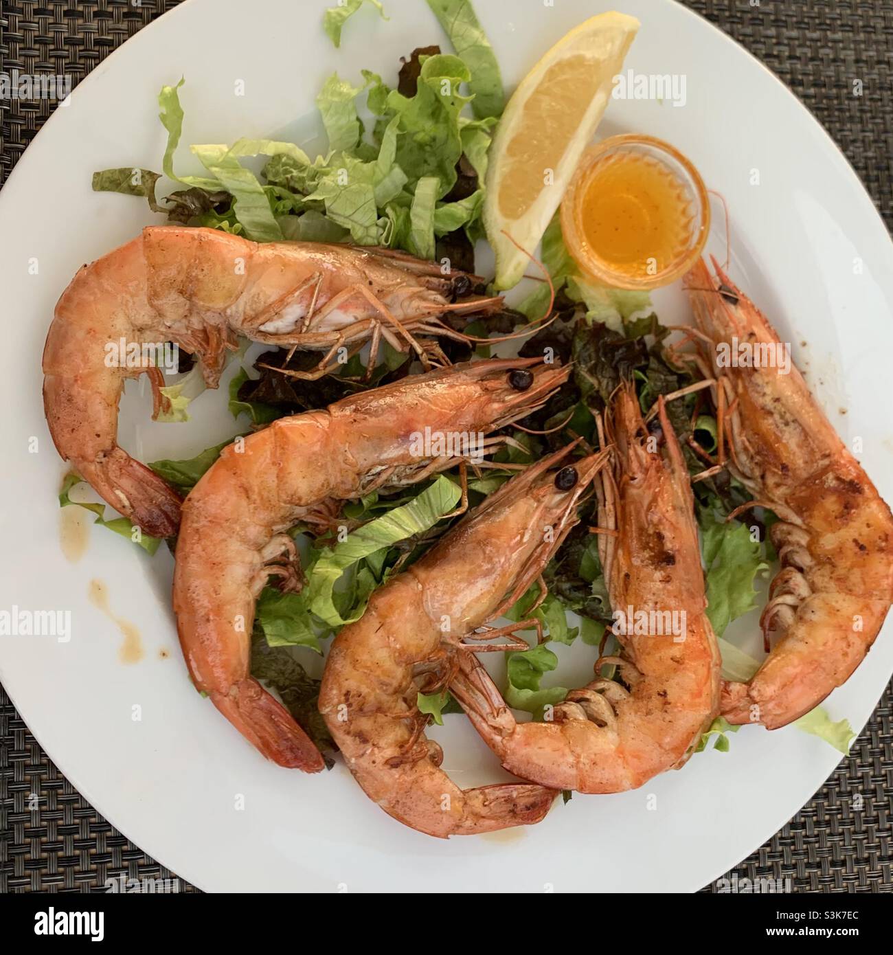 Ein Teller mit großen Garnelen mit einer Scheibe Loon. Mediterrane Ernährung. Gesunde Meeresfrüchte. Frische Meeresfrüchte. Verbündeter mit Meeresfrüchten Stockfoto