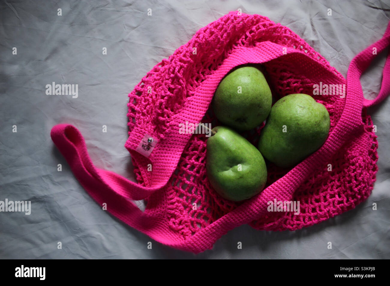 Grüne Birnen im pinken Shopper - Smartphone-aufgenommenes Stockfoto