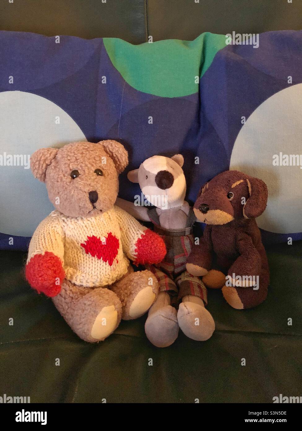 Drei ausgestopfte Tierfreunde sitzen auf der Couch. - Smartphone-aufgenommenes Stockfoto