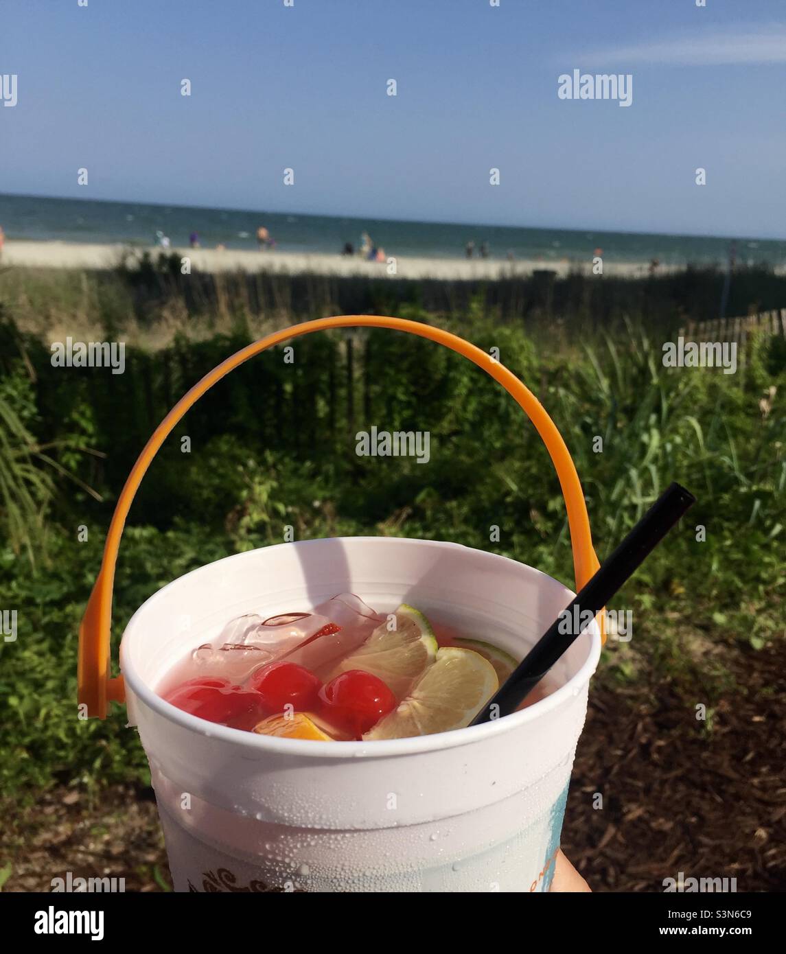 Strandgetränk: Tropisches Eimer-Getränk mit frischem Obst am Strand Stockfoto