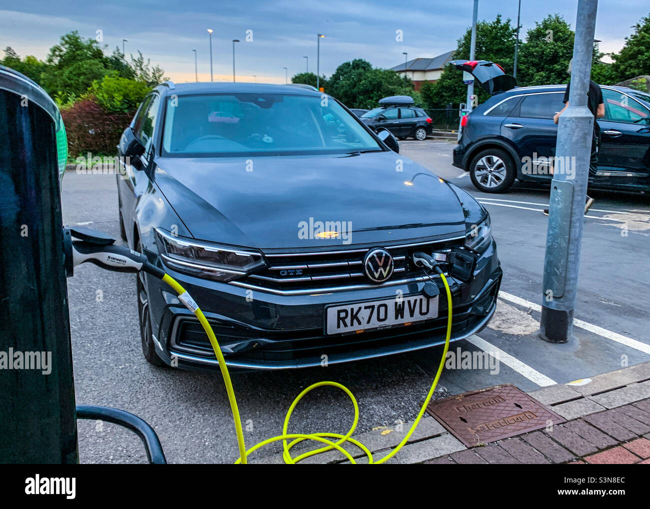 VW-Elektrofahrzeug wird im örtlichen Einkaufszentrum aufgeladen - Smartphone-aufgenommenes Stockfoto