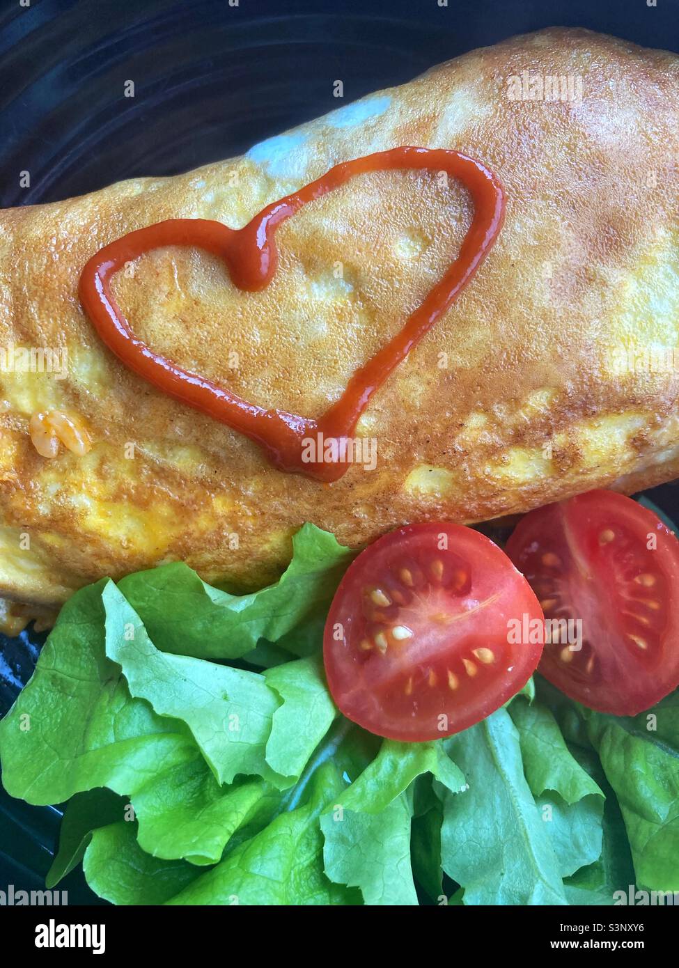 Gefülltes Omelettchen mit einer heißen Soße im Herzen Stockfoto