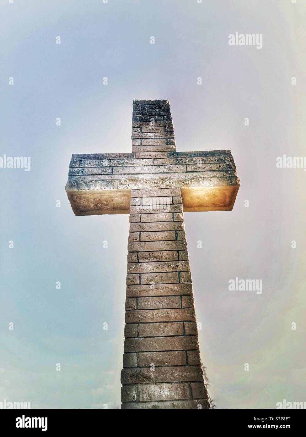 Eine Kreuzstatue aus Stein. Ein Filter wurde hinzugefügt. - Smartphone-aufgenommenes Stockfoto