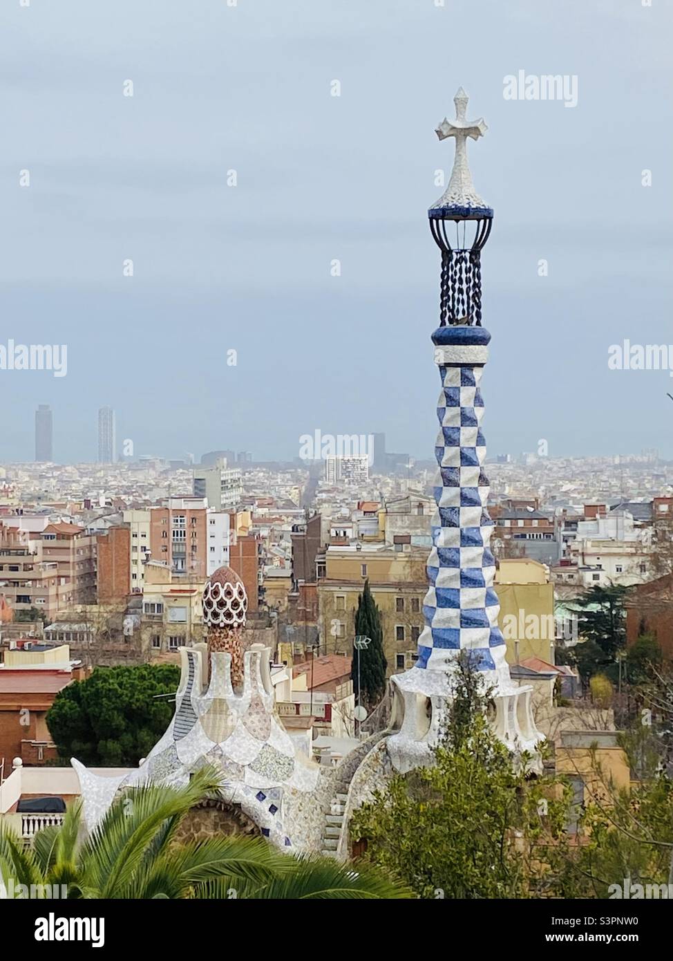 Blick auf das Dach des Pilzhauses im Parc Güell, Barcelona, Katalonien, Spanien, Europa, Und die Stadt vom platz des Parks aus. März 2022. - Smartphone-aufgenommenes Stockfoto