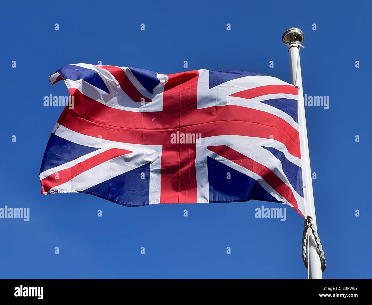 Union Jack gegen einen klaren, blauen Himmel - Smartphone-aufgenommenes Stockfoto