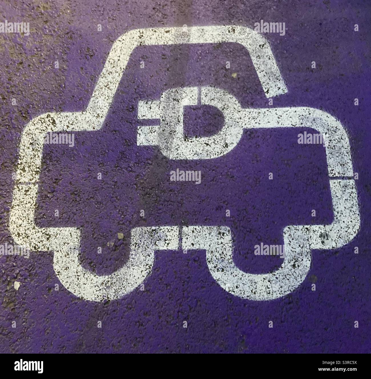 Auf dem Boden lackierter Parkplatz für das Aufladen von Elektrofahrzeugen - Smartphone-aufgenommenes Stockfoto