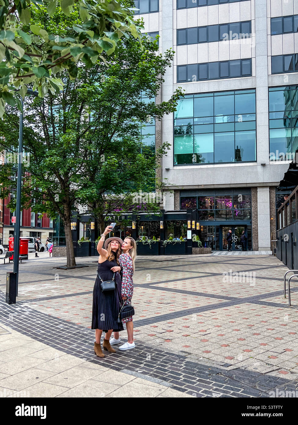 Zwei Frauen, die ein Selfie im Stadtzentrum von Leeds machen Stockfoto