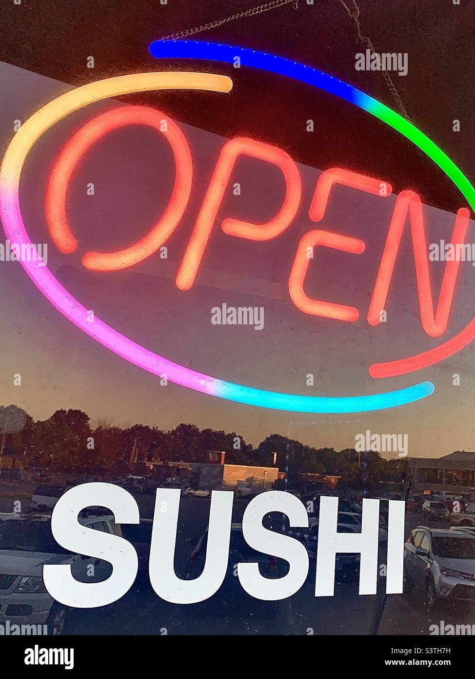 Farbenfrohes, NEONOFFENES Schild am Fenster DES SUSHI-Restaurants Stockfoto