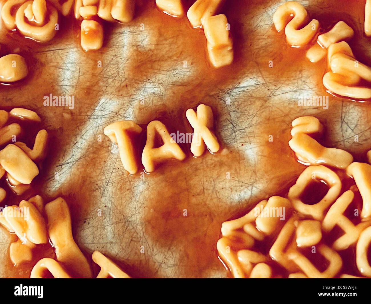 Das Wort ‘Tax’ in der Pasta Alphabeti - Smartphone-aufgenommenes Stockfoto