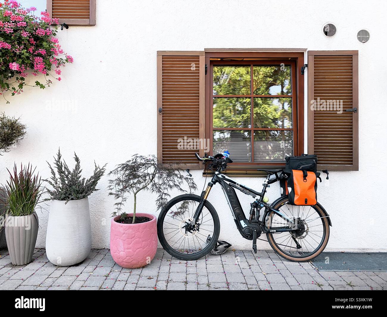 Fahrrad und Pflanzen am Fenster - Smartphone-aufgenommenes Stockfoto