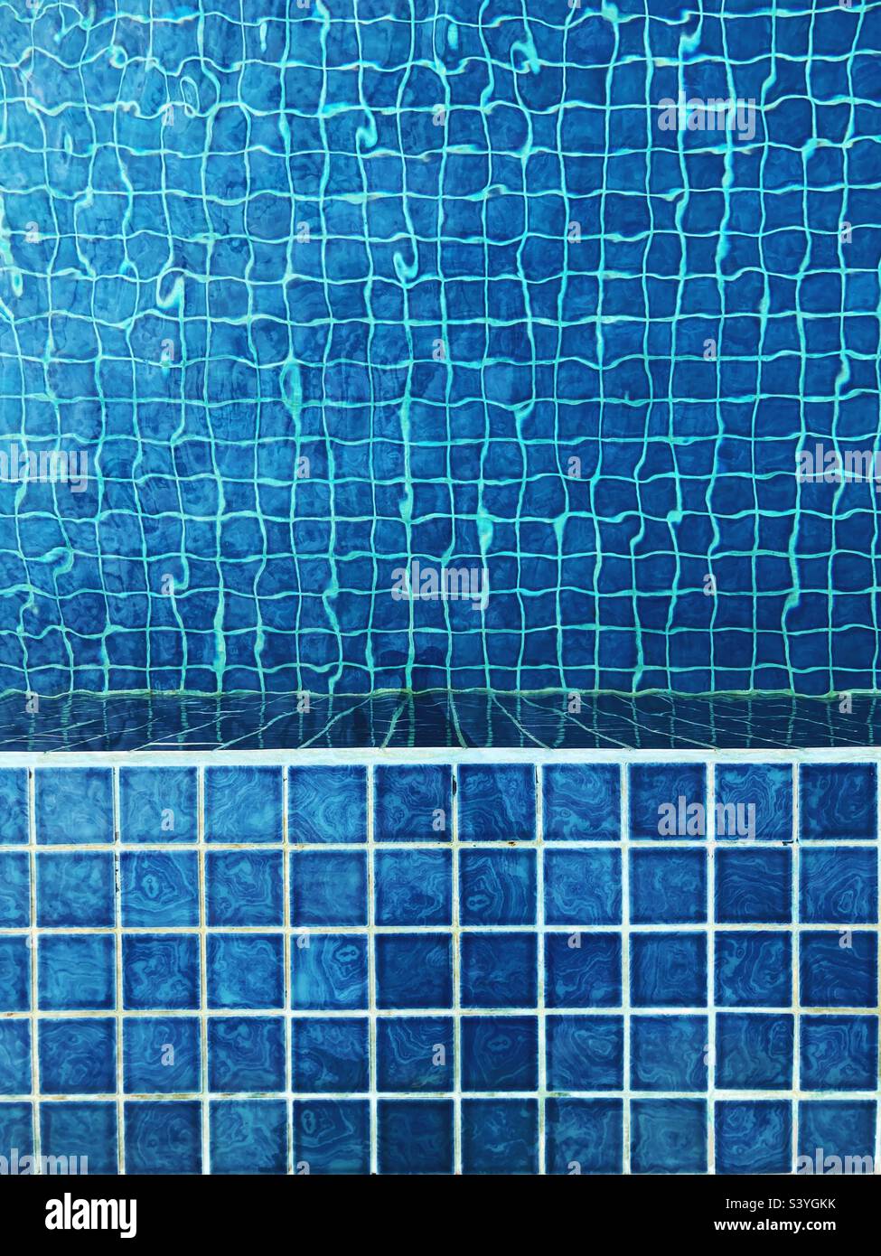 Blaue Fliesen am Rand und in einem Schwimmbad Stockfoto