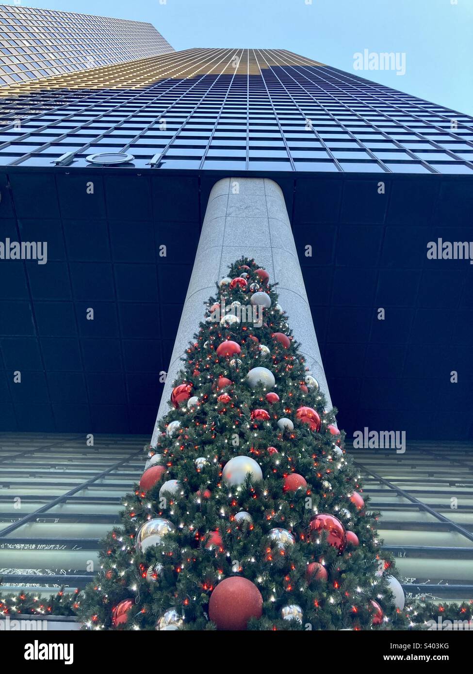 New York, New York, USA – 26. November 2022: Blick auf das Gebäude der Park Avenue 101 mit Weihnachtsbaum bei Nacht. Das Foto sieht das Gebäude am Fluchtpunkt hoch. - Smartphone-aufgenommenes Stockfoto