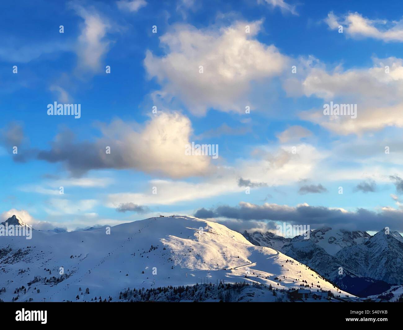 Flauschige Wolken über den verschneiten französischen Alpen. Stockfoto