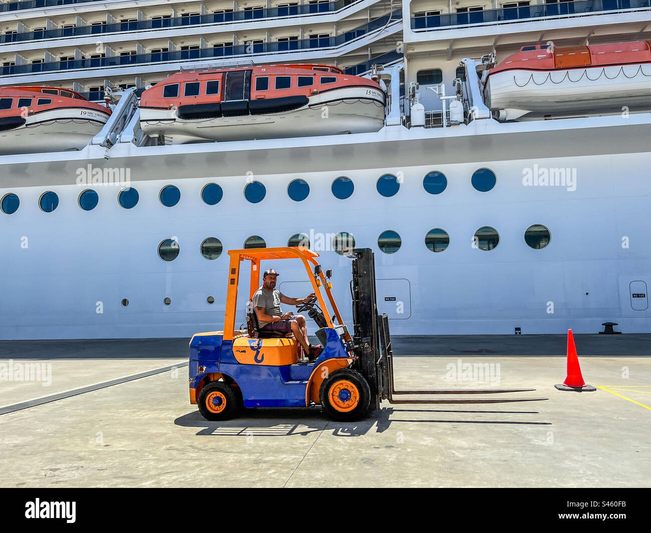 Gabelstapler im Hafen von Lissabon, beladen ein Kreuzfahrtschiff Stockfoto