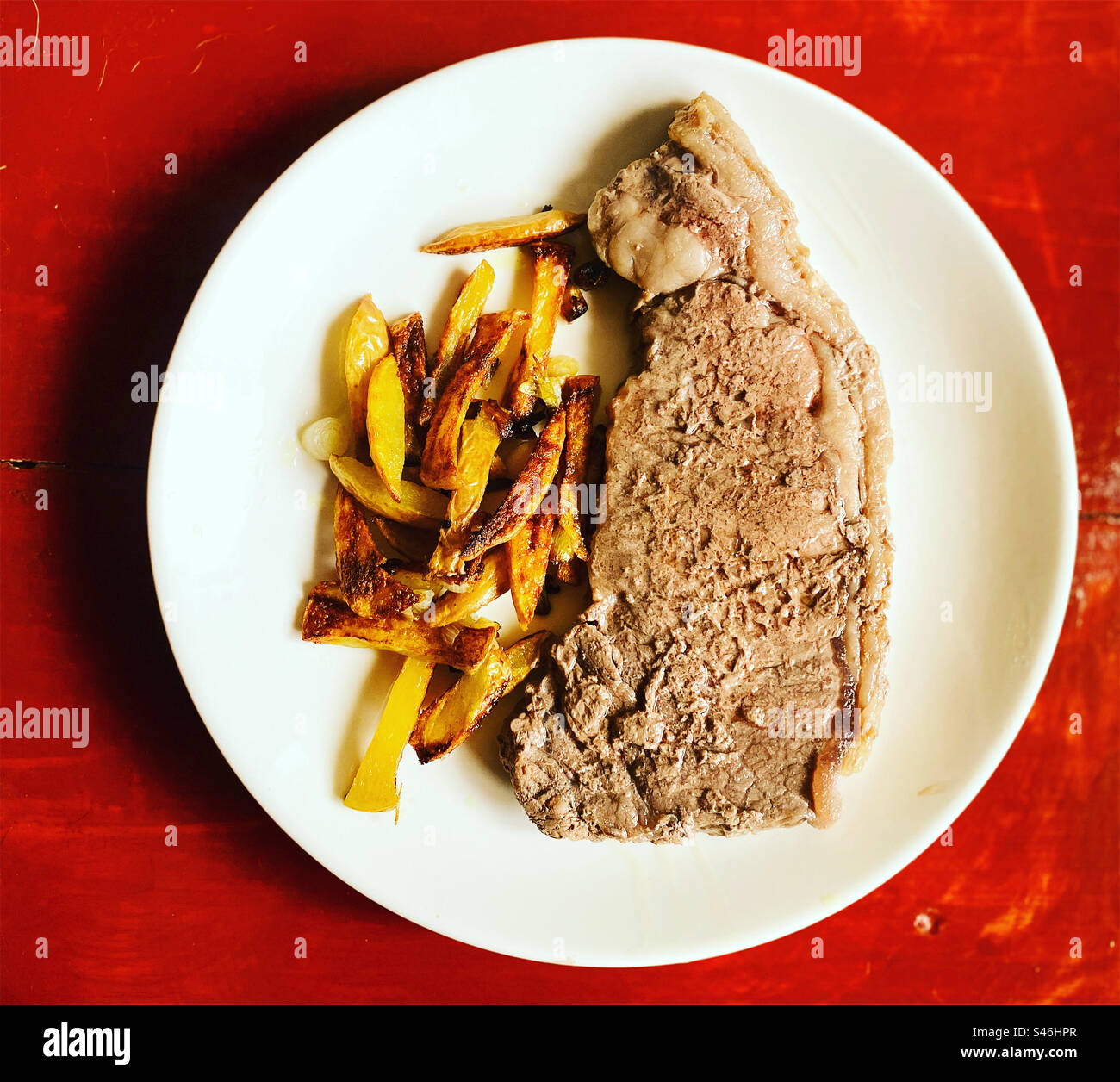 Frittierte knusprige Kartoffeln und ein New Yorker Fleischsteak zum Mittagessen in Mexiko Stockfoto