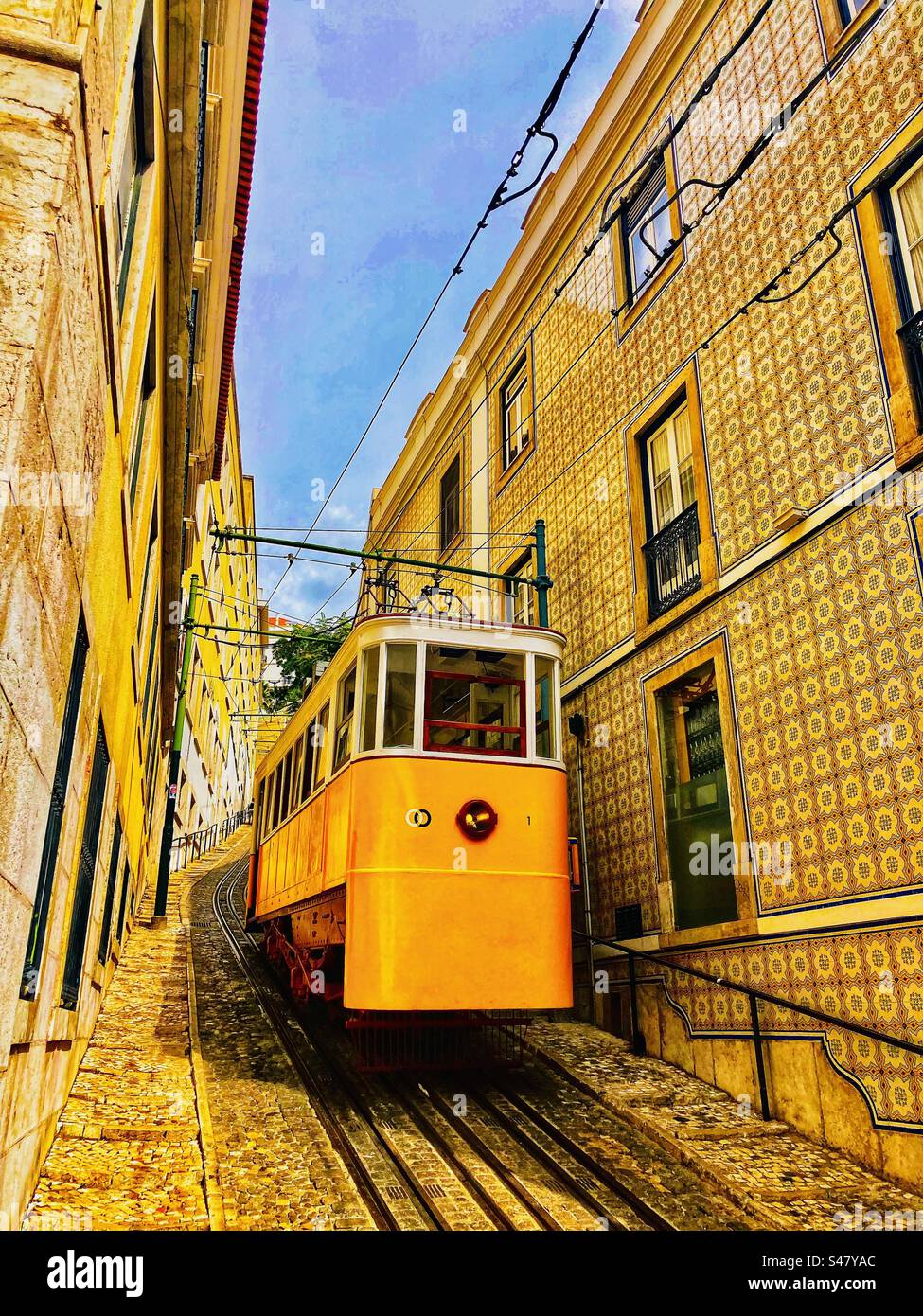 Die gelbe lissabon-Seilbahn in einer engen steilen Straße in Portugal Stockfoto