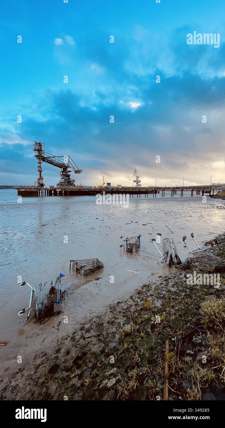 Städtische Landschaft mit Industrieanlagen kombiniert mit verlassenen Einkaufswagen. Zeichnet ein Bild von Verbrechen und einer heruntergekommenen Nachbarschaft. - Smartphone-aufgenommenes Stockfoto