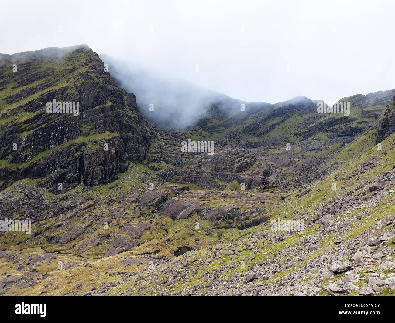 Wolken und schlechtes Wetter ziehen über den Wanderweg auf den Mount Brandon vom FAFA Parkplatz, Cloghane, Dingle Peninsula, Irland - Smartphone-aufgenommenes Stockfoto