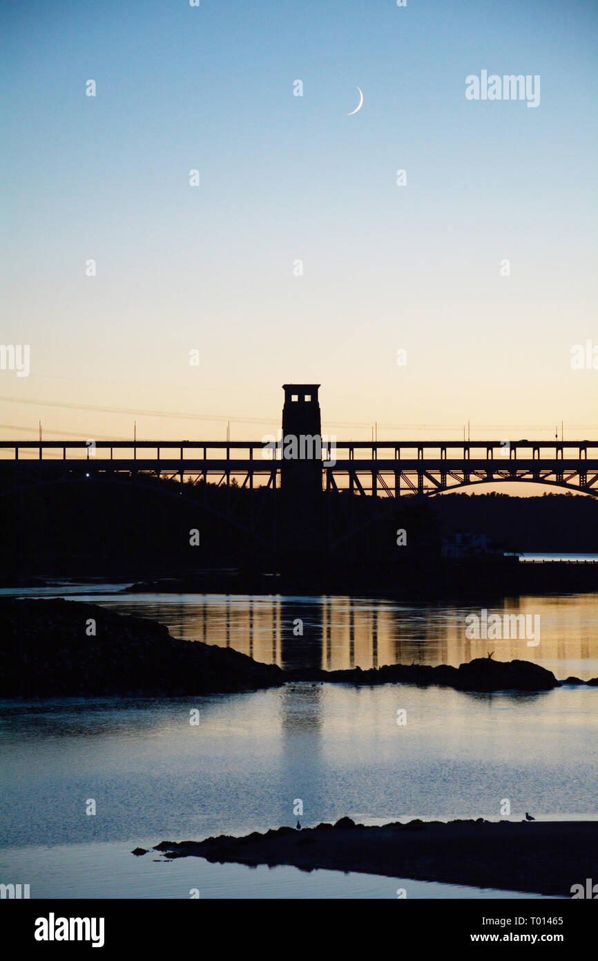 Das Britannia Bridge, die Waliser Festland und Anglesey in der Dämmerung verbindet mit einem Halbmond Stockfoto