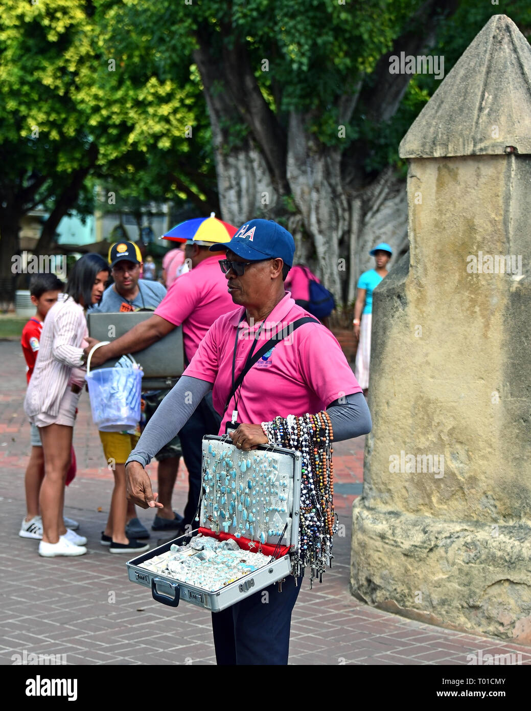 Santo Domingo, Dominikanische Republik - Februar 7, 2019: Street Hersteller peddles Katholische Rosenkränze und Schmuck, darunter einige, die mit der beliebten Larima Stockfoto