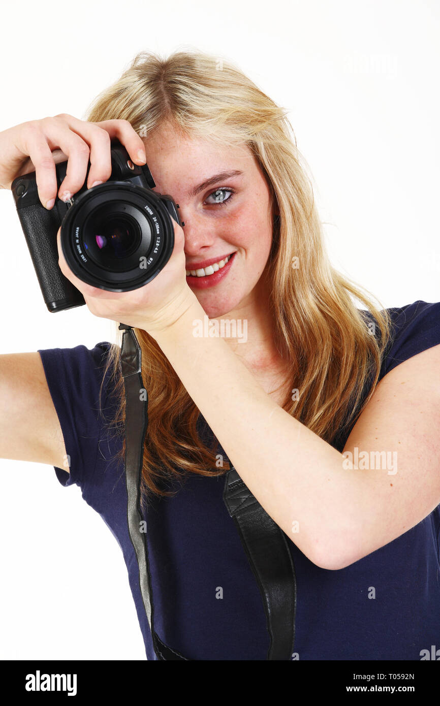 Eine Junge Frau Halt Eine Kamera Vor Den Augen Und Lachelt Gegen Einen Weissen Hintergrund Stockfotografie Alamy