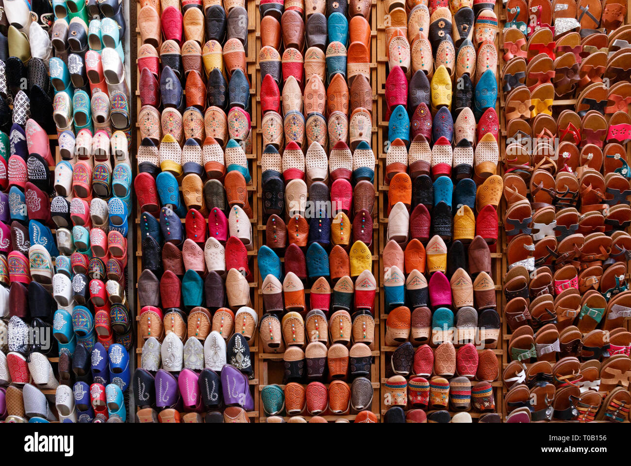 Unzählige bunte Schuhe und Hausschuhe zu einem Souvenirshop in der Medina von Fes, Marokko. Stockfoto