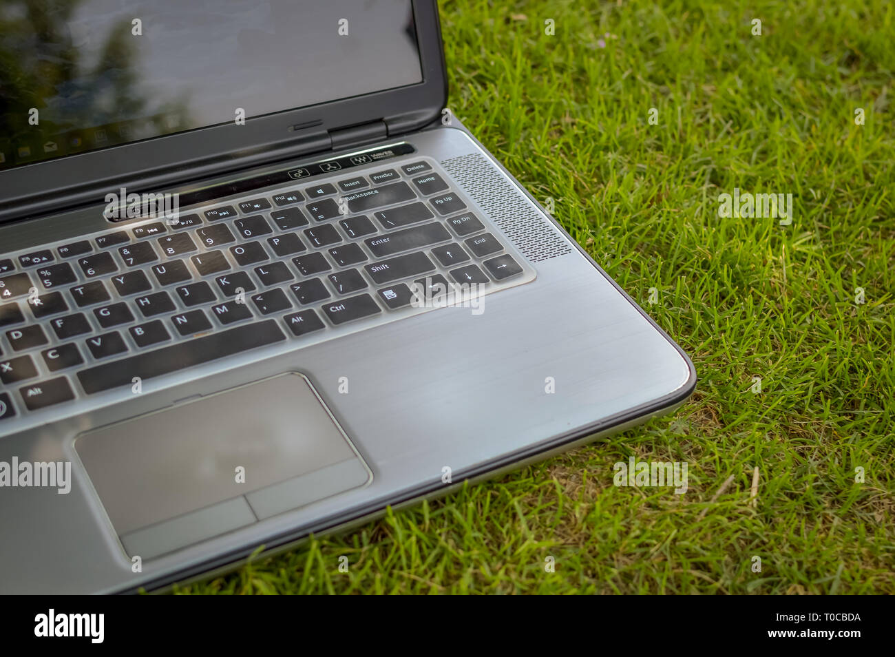 Srinagar, Jammu und Kaschmir, Indien - Stand: Juli 14, 2018: Ein Laptop auf grünem Gras in einem öffentlichen Park gehalten Stockfoto