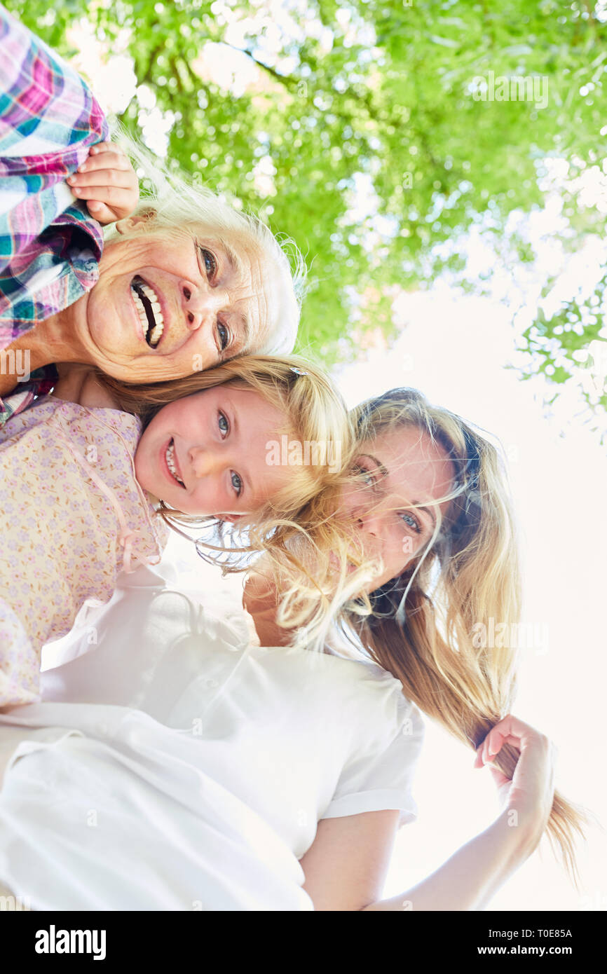 Happy girl als Enkelin mit Mutter und Großmutter in der Sonne Stockfoto