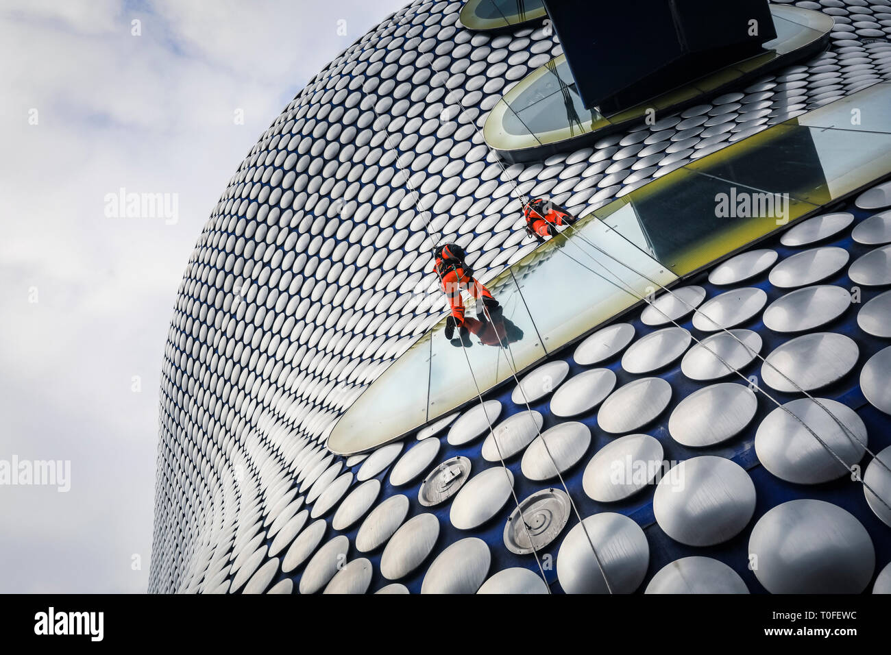 Die Stierkampfarena, Birmingham, UK, 19. März 2019. Eine Gruppe von Seil Reinigung und Wartung Fremdfirmen arbeiten in luftiger Höhe auf dem berühmten Fassade der Selfridges in Birmingham Bull Ring Einkaufszentrum. Die Arbeit ist Teil einer geplanten laufenden Projekts. Die selfridges Gebäude ist in 15.000 überdachte Aluminium Scheiben auf einem blauen Hintergrund gesponnen. Credit: Imageplotter/Alamy leben Nachrichten Stockfoto