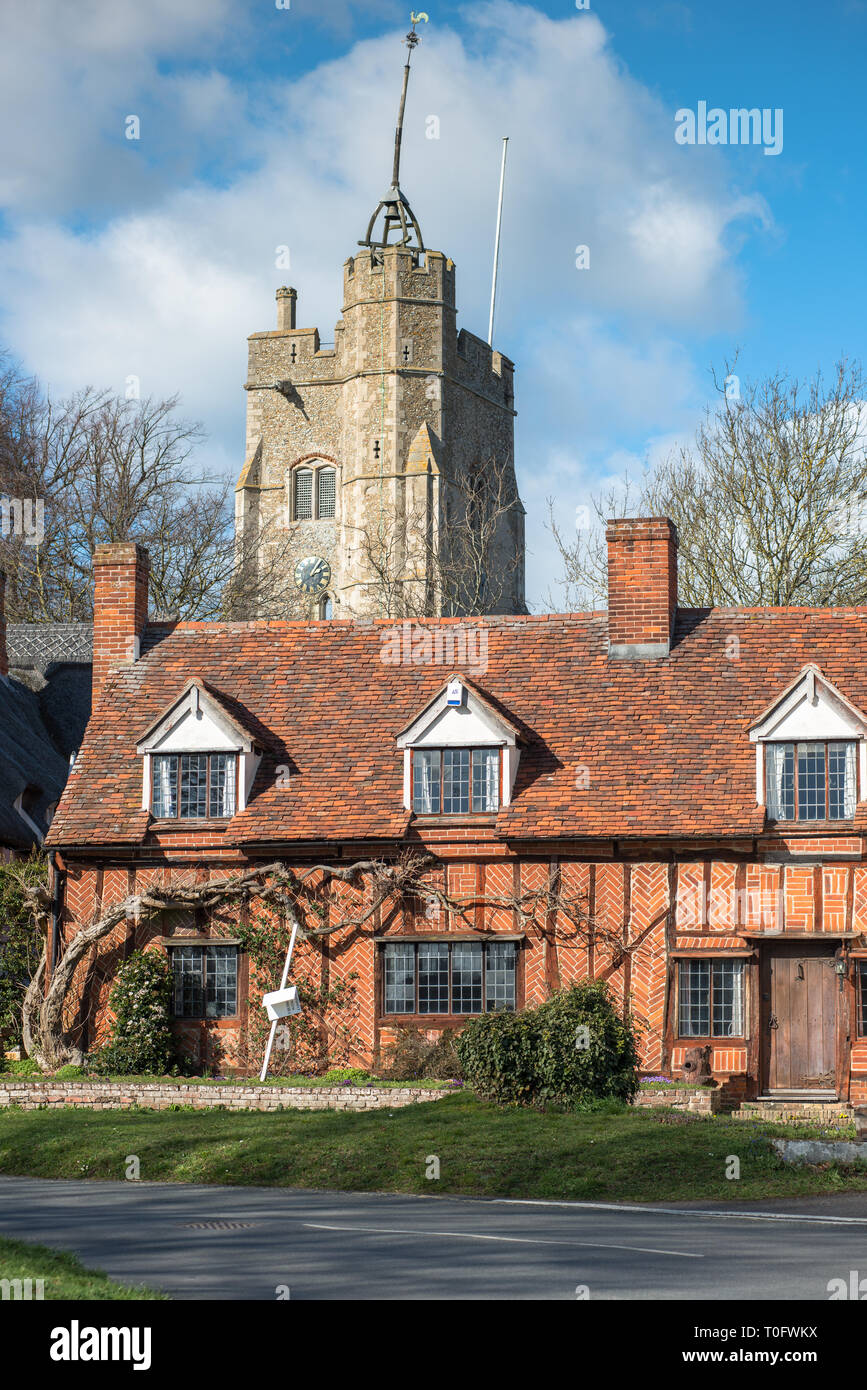 Fachwerk Häuschen mit St. Maria der Jungfrau Kirche auf dem Dorfplatz. Cavendish, Suffolk, East Anglia, Großbritannien. Stockfoto