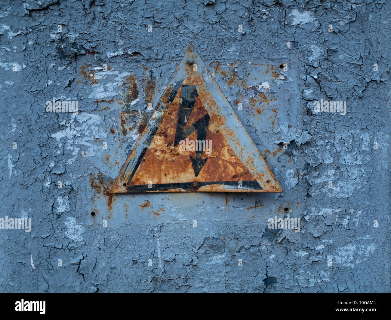 Vintage verwitterten Hochspannungswarnung Warnschild mit Blitz auf alten rostigen Umspannwerk Panel Stockfoto
