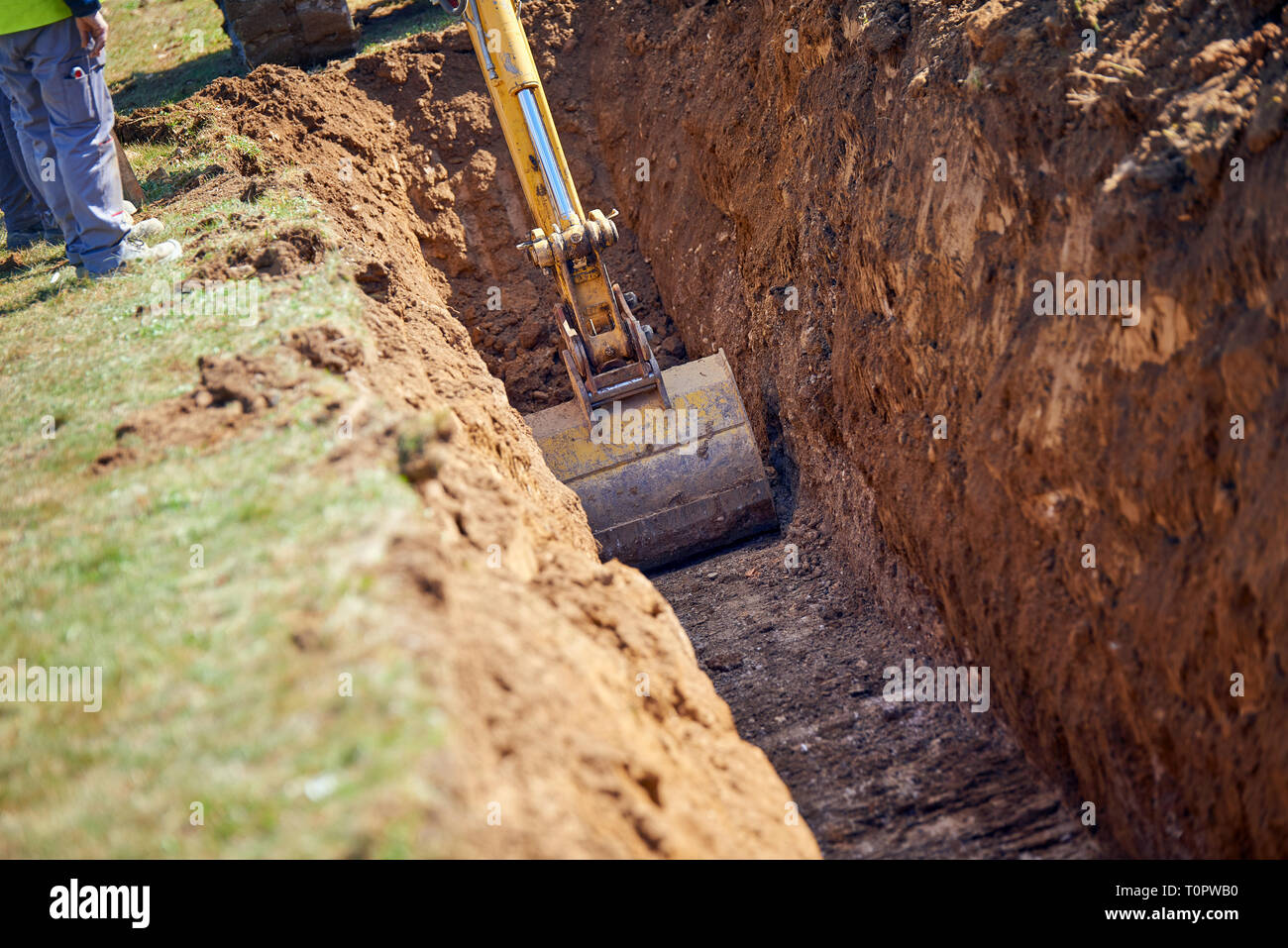 Tiefenlöffel-Graben Bagger gräbt die Grundlage für Wasserleitungen Stockfoto