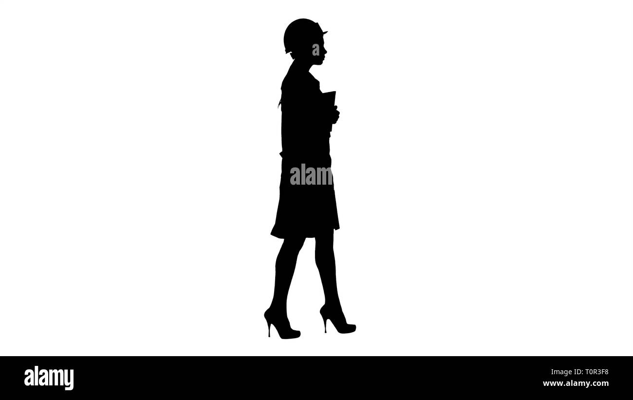 Silhouette attraktive Hispanic Frau im weißen Kittel und weißen Sicherheit harten Hut wandern Holding Notebook oder Tablet-PC. Stockfoto