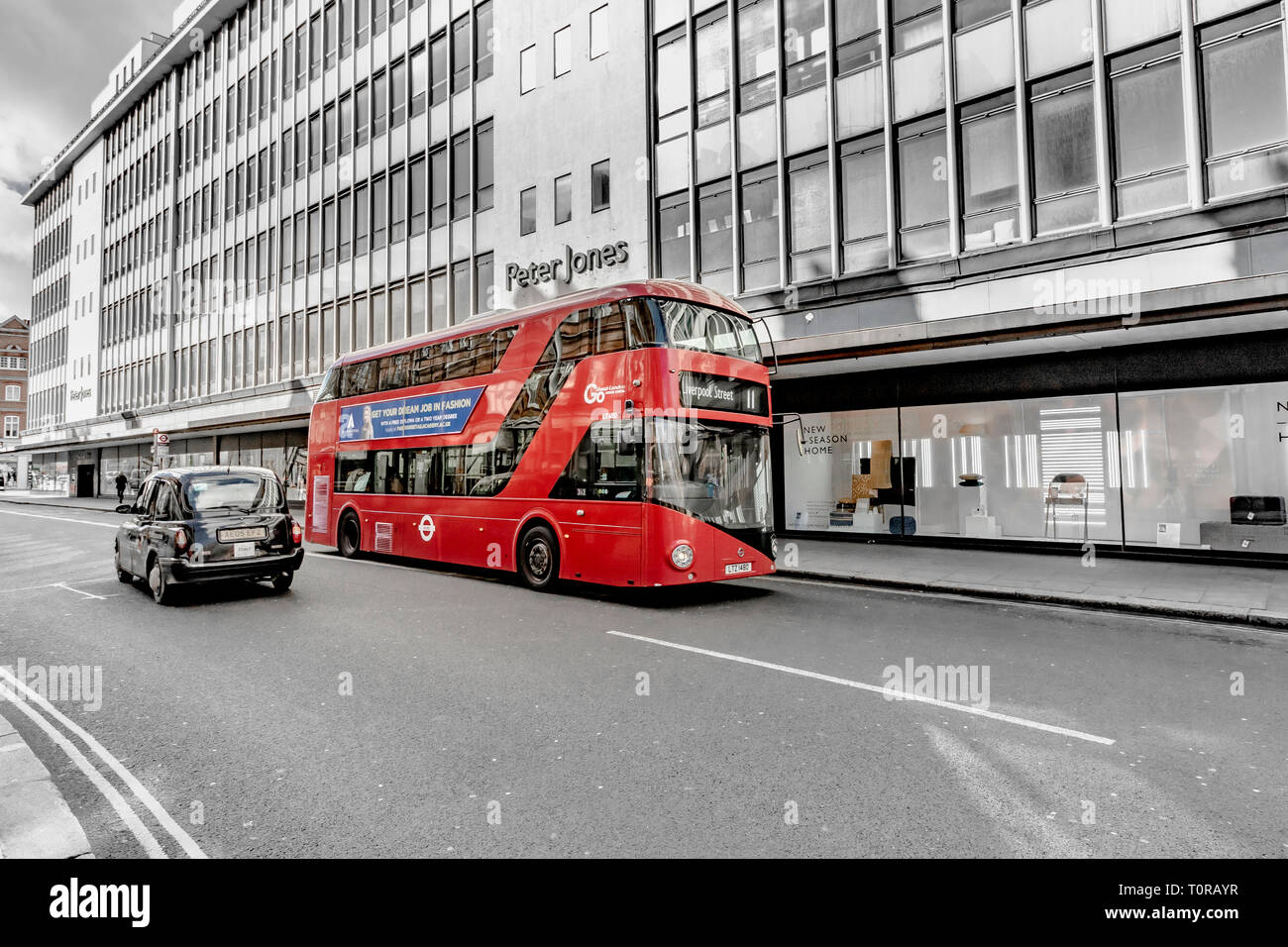 Ein London Black Taxi fährt an einem Doppeldeckerbus der Nummer 11 in London auf der Kings Road vorbei, vor dem Peter Jones Kaufhaus in Sloane Square, London, Großbritannien Stockfoto