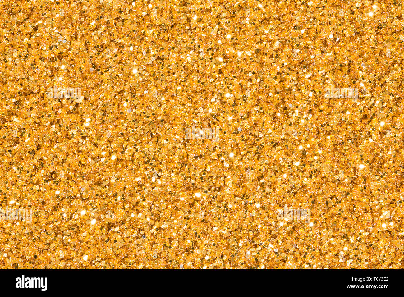 Licht golden glitter Hintergrund mit Brillanz. Helle golden glitter Textur. Stockfoto