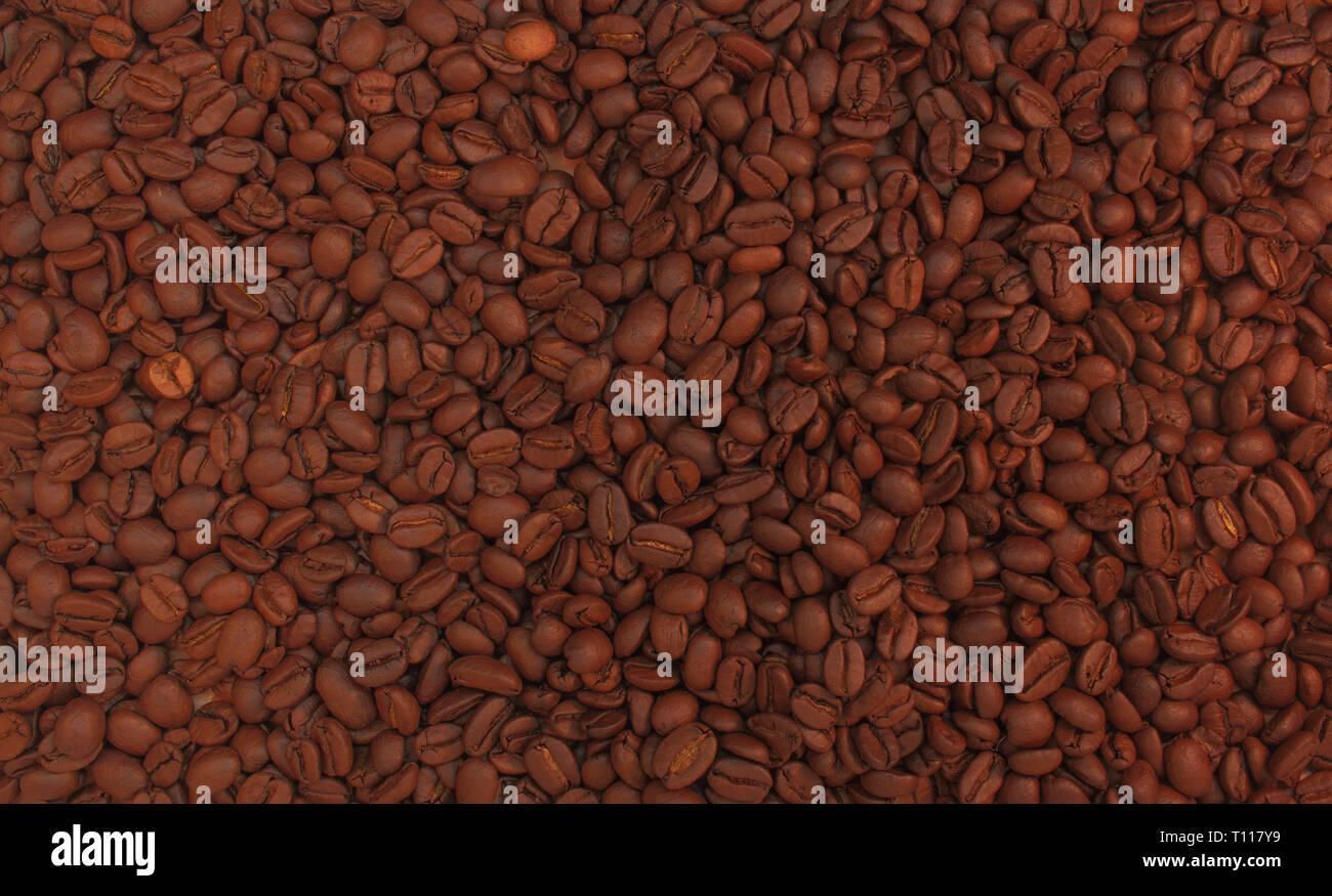 Geröstete Kaffeebohnen Hintergrund. Aroma Koffein trinken Zutat für Kaffee trinken. Close-up ruhigen Tonfall braune Textur. Stockfoto