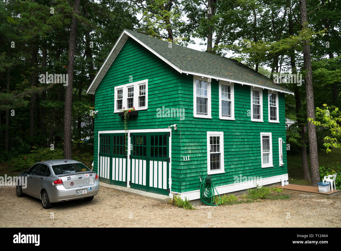Helle grüne geschuppt Haus mit weißen Garnituren und breite Doppeltüren, Scarborough, Maine, USA. Stockfoto