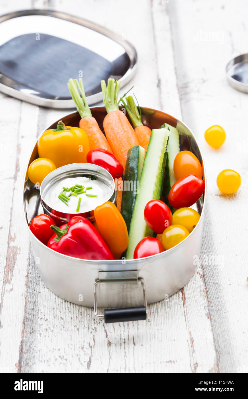 Lunch Box mit Karotte, Paprika, Gurke, Tomaten und Schnittlauch dip Stockfoto