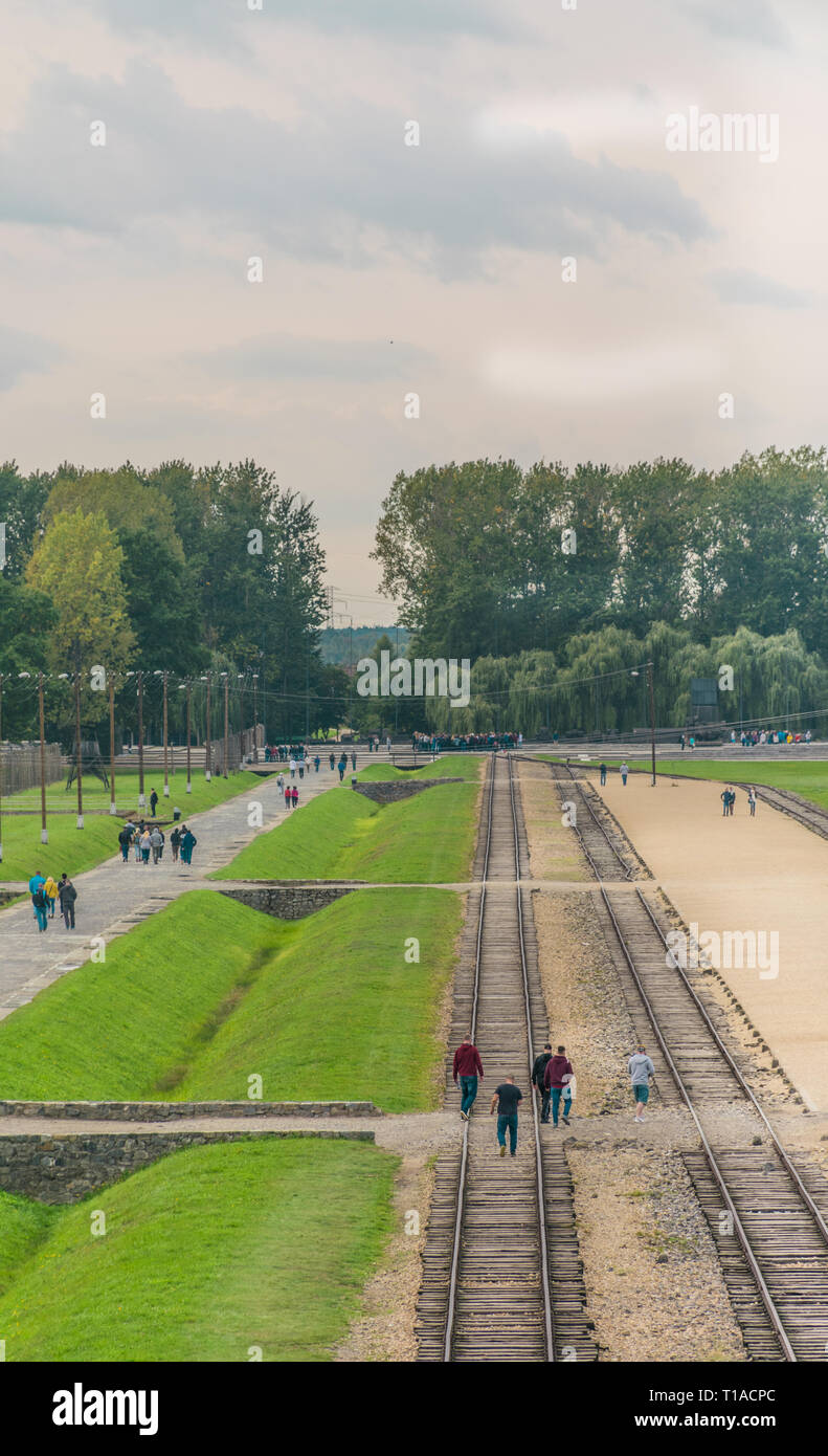 Oswiencim, Polen - 21. September 2019: Touristen zu Fuß entlang der Bahnlinie, wo der Wagen mit der Birkenau Gefangenen angekommen. Stockfoto