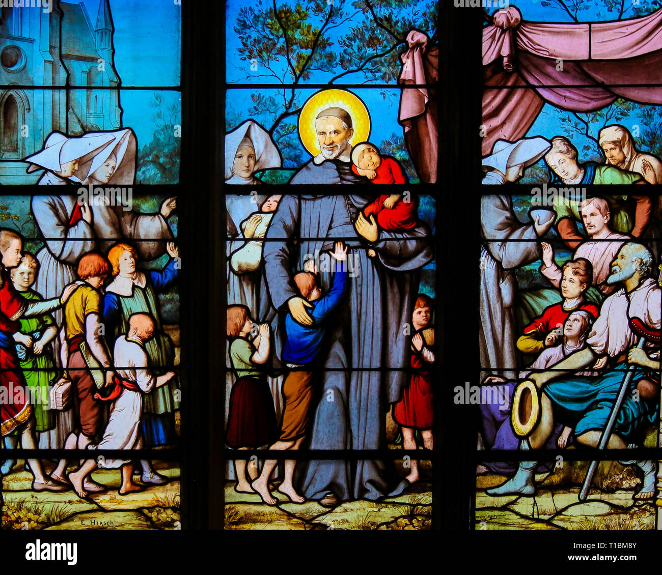 Glasmalereien in der Kirche von St. Severin, Latin, Paris, Frankreich, Saint Vincent de Paul und Kinder. Stockfoto