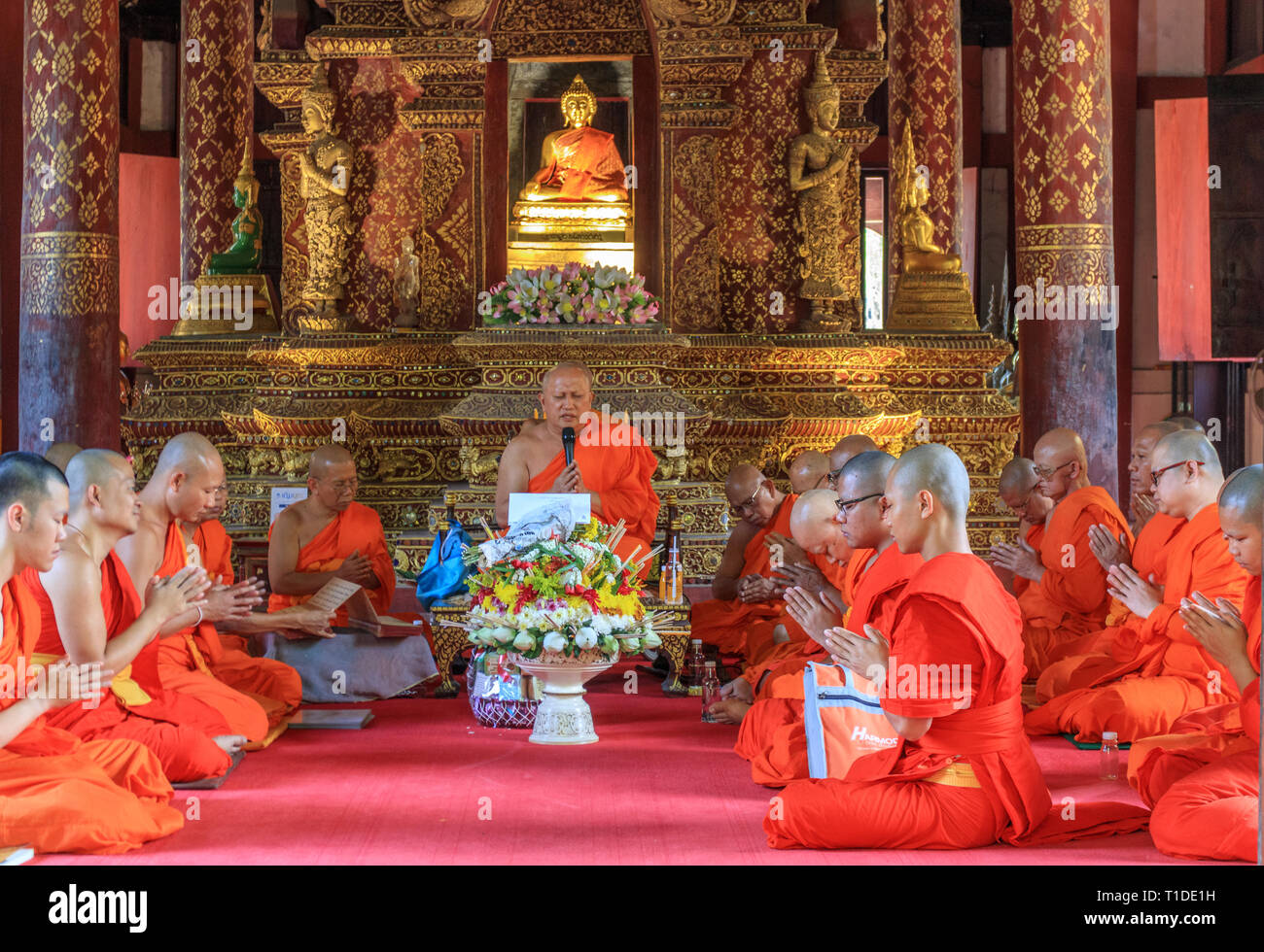 Eine Gruppe von Mönchen, die im Gebet im Innern des Wat Pra singen Tempel versammelt Stockfoto