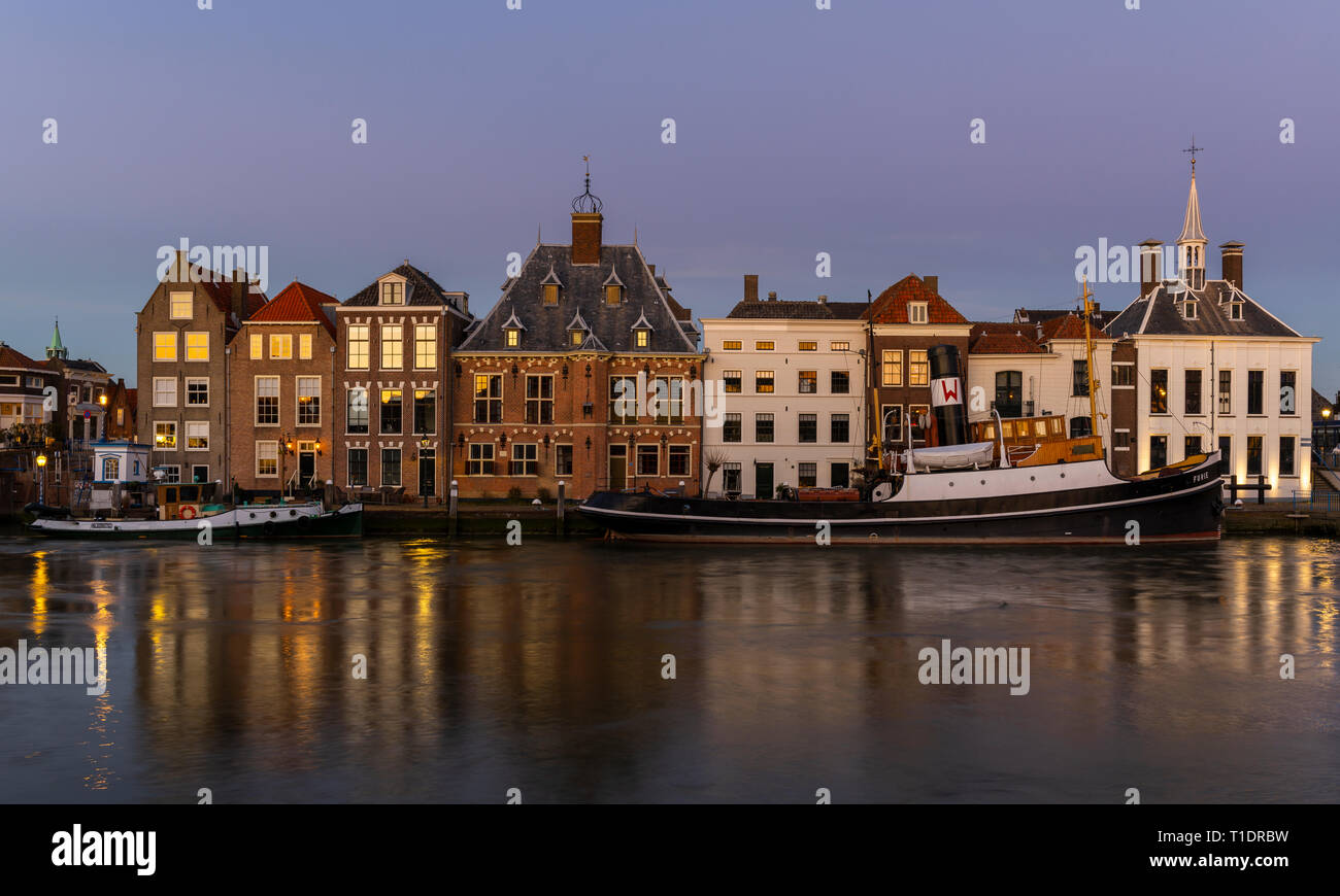 Maassluis, Niederlande - 26. Februar 2019: Der Hafen von Maassluis mit alten Boote, Schlepper und monumentale Häuser in der Nacht. Stockfoto