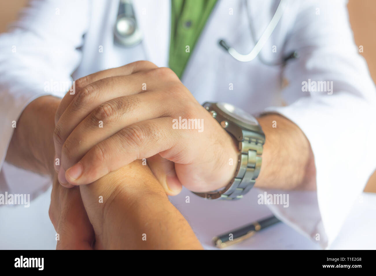 Ein Arzt mit einem Patienten die Hand schütteln und ihm eine Geste der Hoffnung Stockfoto
