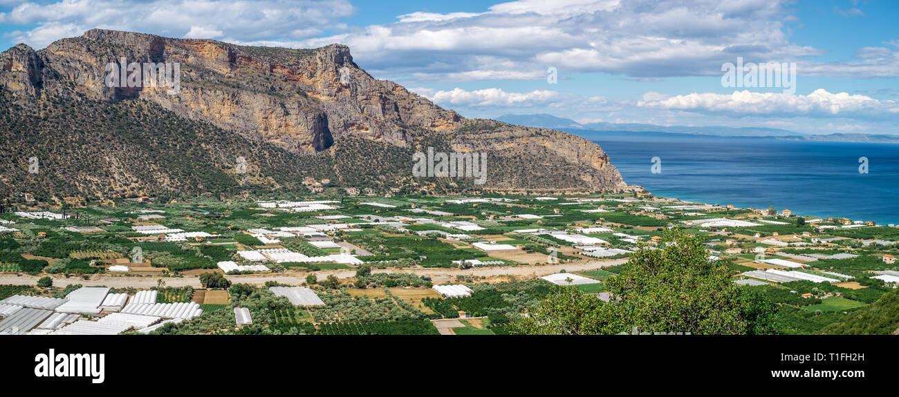 Gewächshäuser und bewirtschafteten Feldern durch das Meer. Lakkos, Peloponnes, Griechenland. Stockfoto
