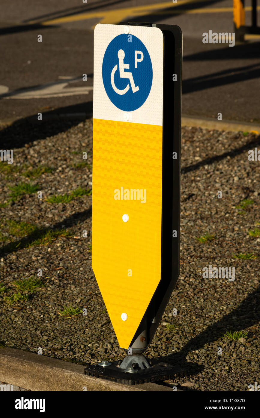 Flexible gelb Poller. Rollstuhl Symbol auf gelbem Parkplatz Poller mit reservierten Parkplatz für behinderte Fahrer Stockfoto
