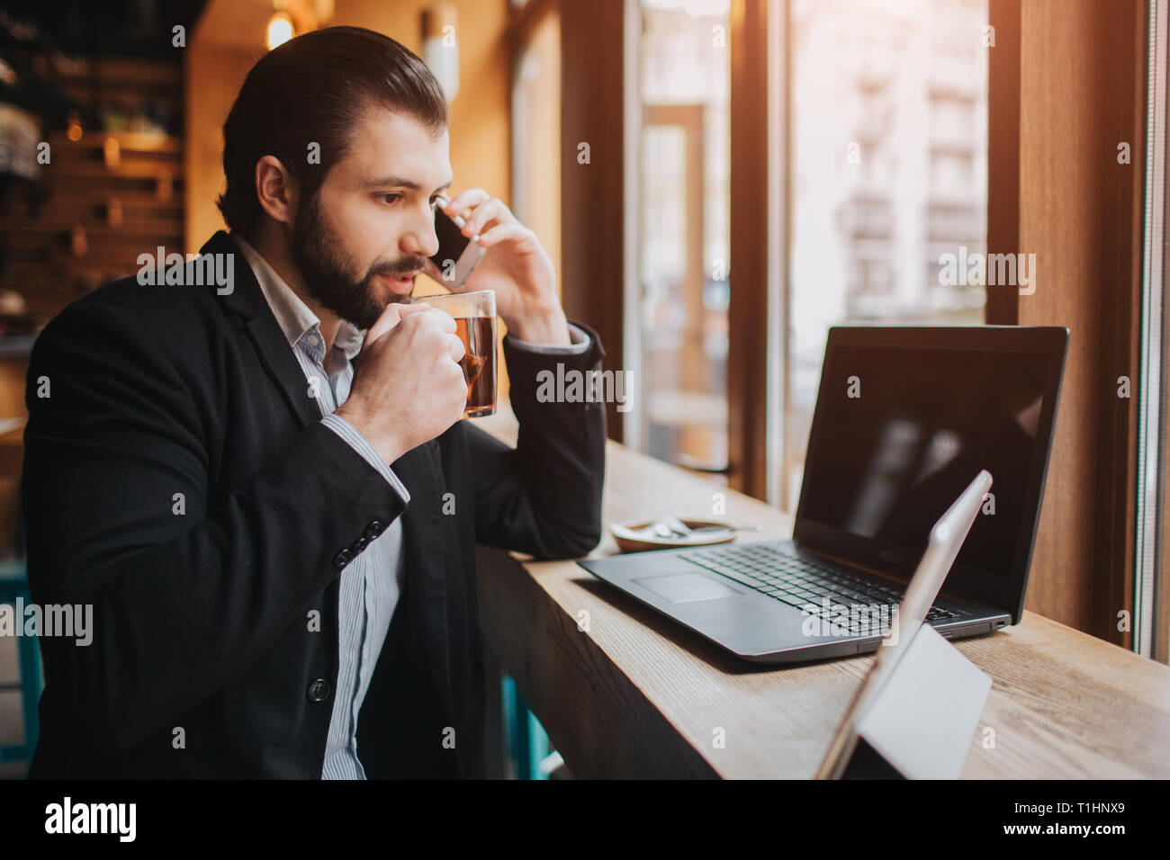 Viel beschäftigter Mann ist in Eile, hat er keine Zeit, er geht zu essen und zu arbeiten. Arbeitnehmer essen, trinken Kaffee, telefonieren, gleichzeitig Stockfoto