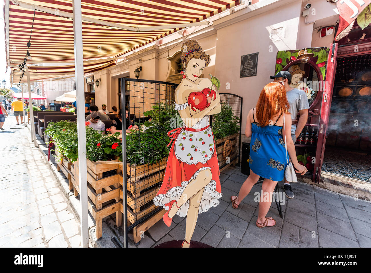 Lemberg, Ukraine - August 1, 2018: Street im historischen Ukrainischen polnischen Lvov Stadt bei Tag mit gelben alten Vintage Gebäude in der Altstadt, Menschen sitzen Stockfoto