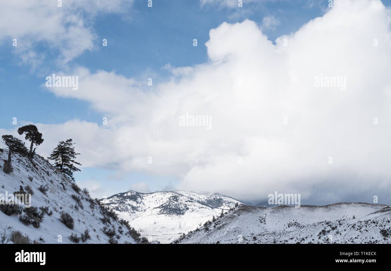 Malerischer Blick auf Wolken über Schnee - covered​ Berge im Yellowstone National Park im Winter. Stockfoto