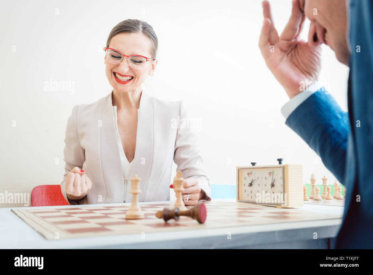 Geschäftsfrau gewinnen im Schach durch bessere Strategie Stockfoto